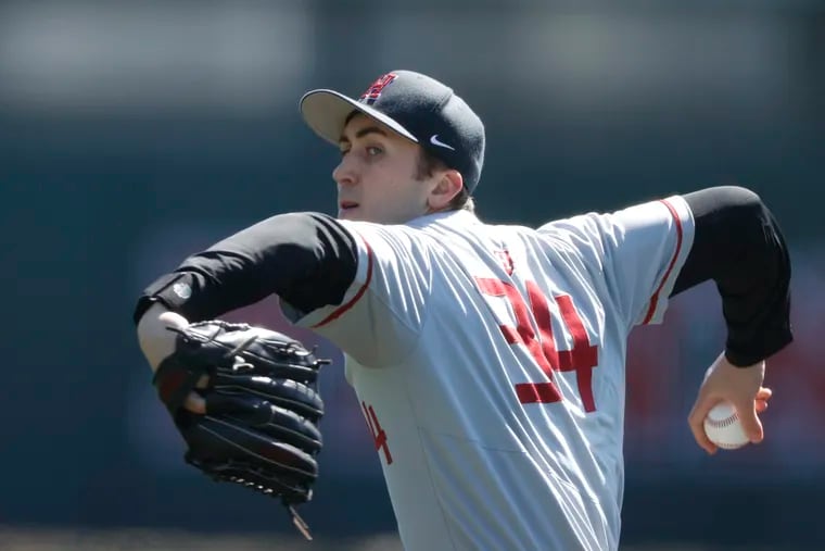 Harvard pitcher Chris Clark throws against Penn during a game on March 26.