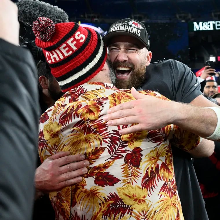 Jason Kelce embraces his brother, Kansas City Chiefs tight end Travis Kelce, after the AFC championship game as Taylor Swift watches.