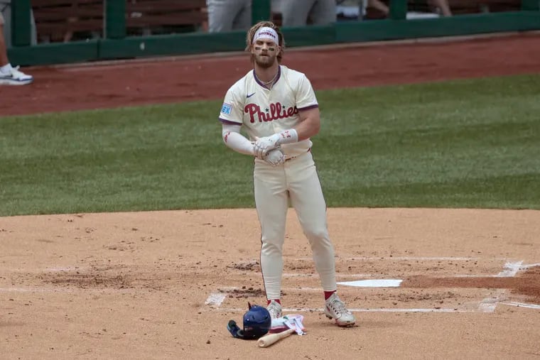 Bryce Harper stands at home plate after striking out to end the first inning of the Phillies' loss to the Yankees on Wednesday.