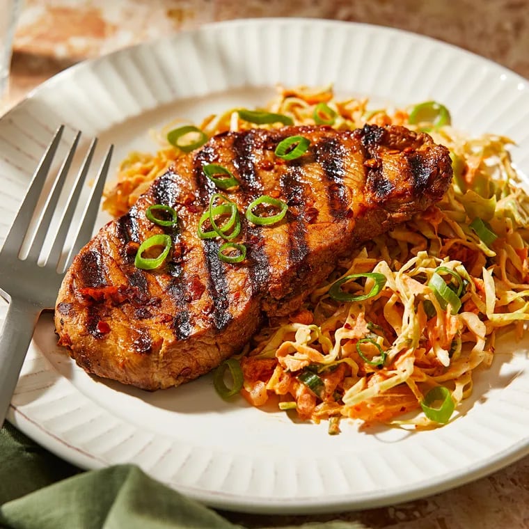 Chili Crisp Pork Chops With Kimchi Slaw. MUST CREDIT: Tom McCorkle for The Washington Post; food styling by Gina Nistico for The Washington Post