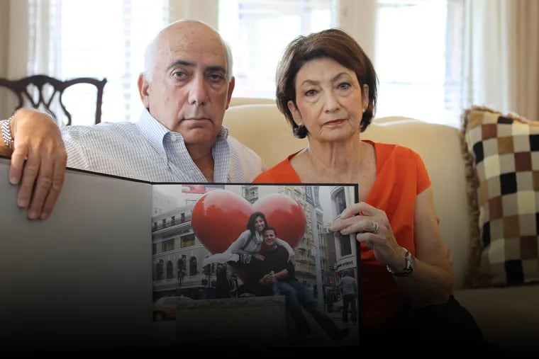 Ellen Greenberg's parents, Joshua and Sandra, at their home in Harrisburg with a photo album of their daughter.