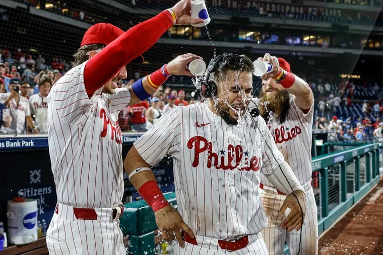 Phillies Rafael Marchán gets a water bath from teammates. Bryson Stott left and Brandon Marsh after beating the Dodgers 10-1 at Citizens Bank Park in Philadelphia, Tuesday, July 9, 2024