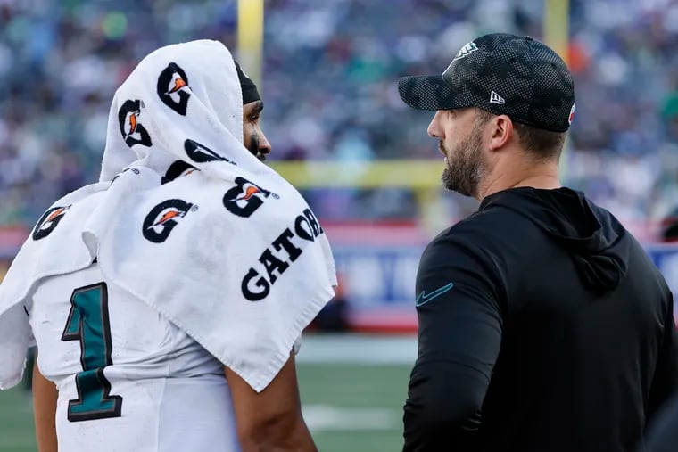 Eagles quarterback Jalen Hurts and coach Nick Sirianni talk during their 28-3 victory over the Giants on Sunday.