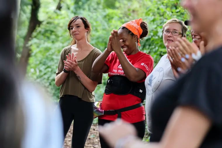 Teachers from Lewis Elkin Elementary School celebrate after completing the ropes course at the Philadelphia Outward Bound Discovery Center in Philadelphia.