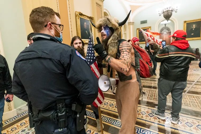 Jacob Anthony Chansley, in the horned headdress, left a note for the vice president indicating the insurrectionists in last week's Capitol riot intended to capture and assassinate lawmakers, prosecutors said.