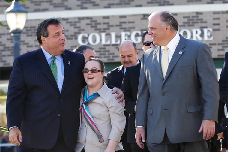 Chris Christie walks with Stephen Sweeney (far right) and Sweeney's daughter Lauren at Gloucester County College on Monday, Oct. 21, 2013.