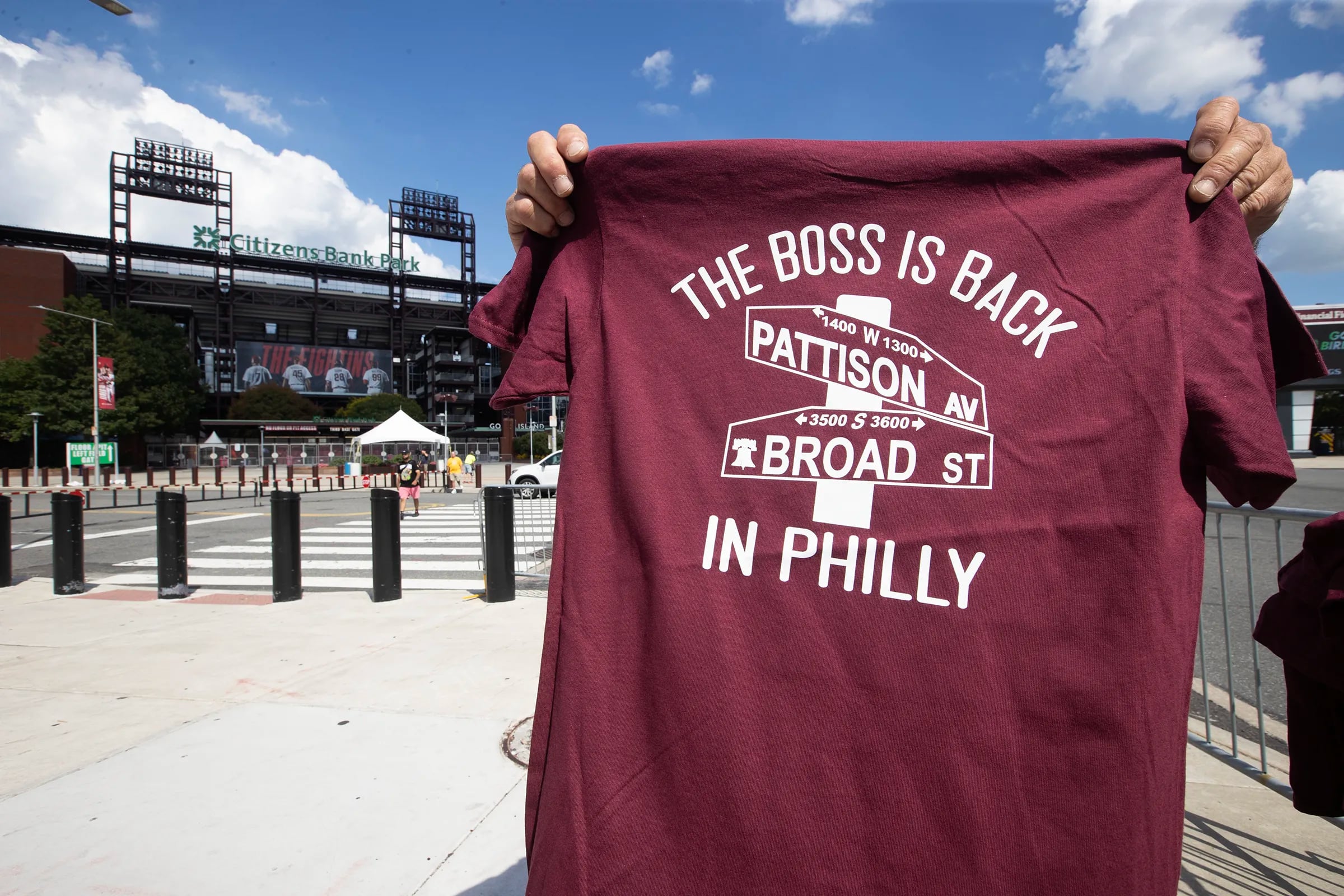 Bruce Springsteen canceled his 2 Philadelphia shows at Citizens Bank Park due to illness on Aug. 16, 2023. A T-shirt vendor tries to sell some shirts to salvage the day. He did not want to be photographed.