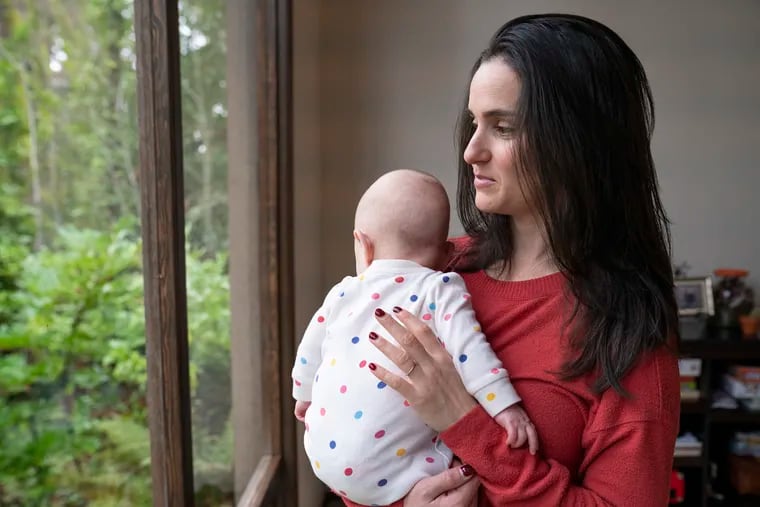 Danielle Laskey at her home just outside Seattle, with her infant son. Before giving birth, Laskey experienced a serious pregnancy complication and was admitted for a seven-week hospital stay, plus a follow-up postpartum procedure.