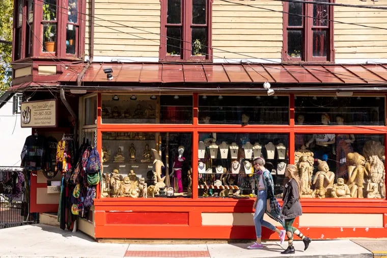 Julia Levis of New Hope and friend Sydney Norris of West Philadelphia walk pass Three Cranes Gallery along Main Street in New Hope.