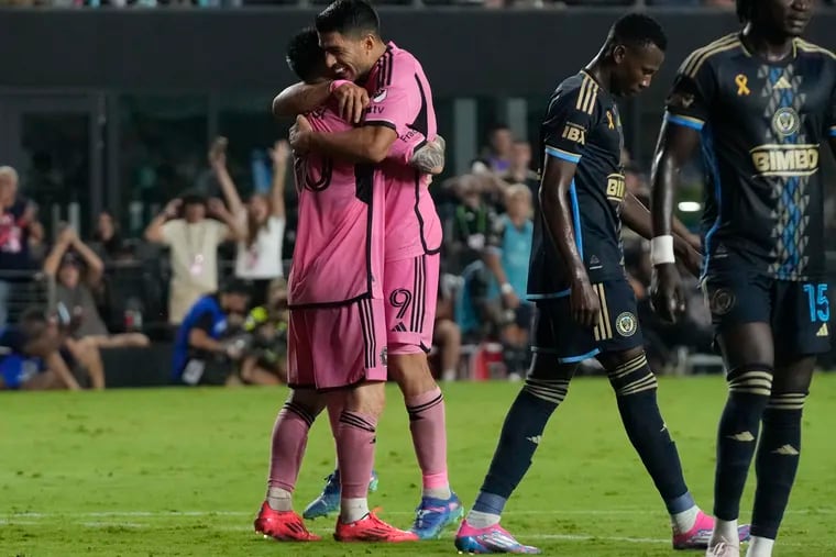 Inter Miami superstars Lionel Messi (left) and Luis Suárez embrace after Messi assisted on Suárez's late goal in Miami's 3-1 win over the Union on Saturday.