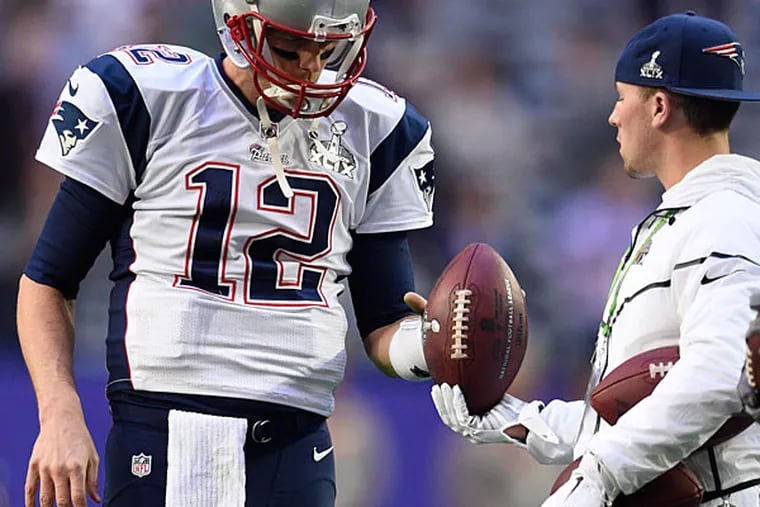 New England Patriots quarterback Tom Brady warms up before their