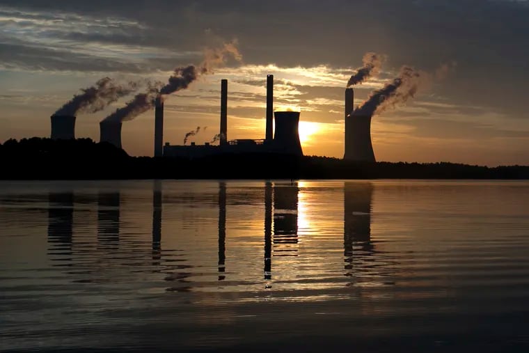 FILE - In this June, 3, 2017, file photo, the sun sets behind Georgia Power's coal-fired Plant Scherer, one of the nation's top carbon dioxide emitters, in Juliette, Ga. As climate change becomes a hotter topic in American classrooms in 2019, some politicians are pushing back against the scientific consensus that global warming is real and man-made. (AP Photo/Branden Camp, File)