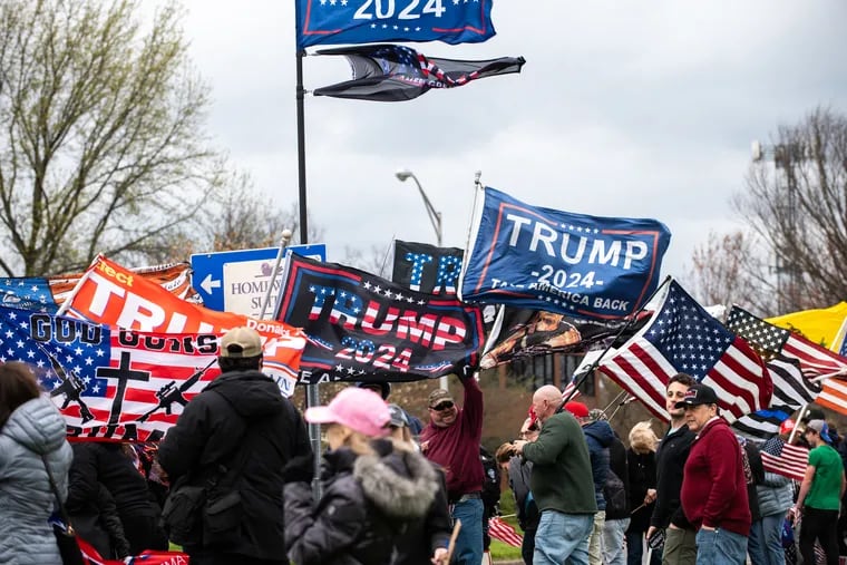 Trump supporters gather outside of Newtown Athletic Club during a fundraising event for former President Donald Trump on Saturday, April 13, 2024 in Bucks County, Pa. Some supporters gained entry to the invitation-only event while those who could not afford the entry fee chose to gather for a ‘street rally’ outside the venue to show their support.