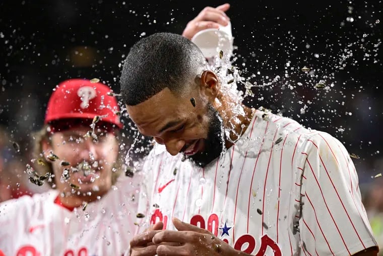 Phillies starter Cristopher Sánchez is doused by teammates Saturday night after a two-hit complete game in a 5-1 victory over the Nationals.