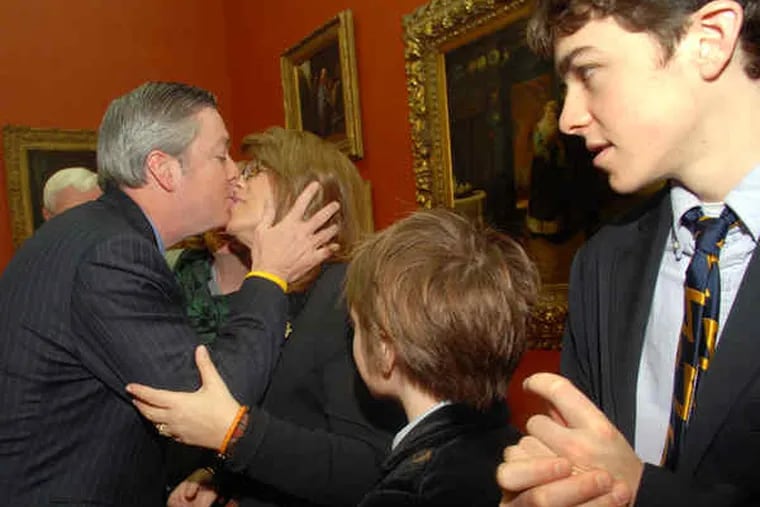 John Fry kisses his wife Cara at a news conference after his election. With them yesterday were two of their children, Phoebe, 9, and Nat, 15. Daughter Mia, 19, is a freshman in college.