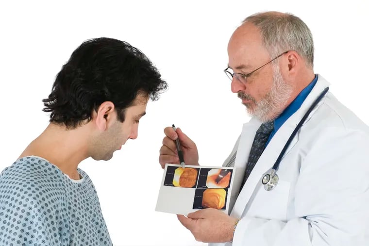 Doctor showing patient the images from his colonoscopy.
