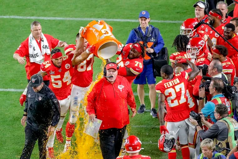 Kansas City Chiefs head coach Andy Reid reacts as players shower him on the sidelines at the conclusion of a 31-20 win against the San Francisco 49ers in Super Bowl LIV at Hard Rock Stadium in Miami Gardens, Fla., on Sunday, Feb. 2, 2020.