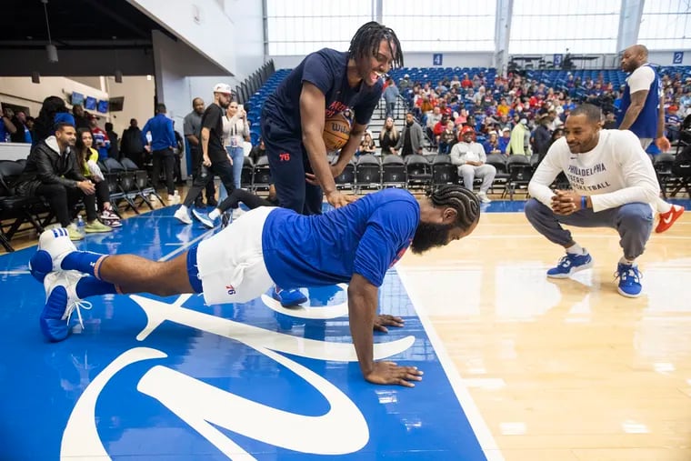 Tyrese Maxey enjoys James Harden doing some push-ups after Harden lost a shooting competition at the team's Blue-White scrimmage in Wilmington on Oct. 14.