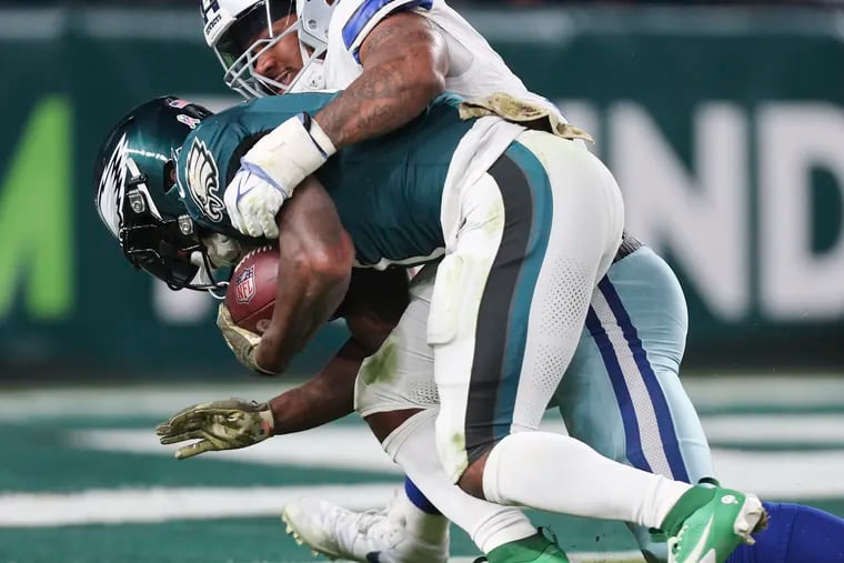 Cowboys linebacker Micah Parsons wrapping up former Eagles running back D'Andre Swift in November. Parsons was impressed by fellow former Penn Stater Saquon Barkley's Eagles debut.