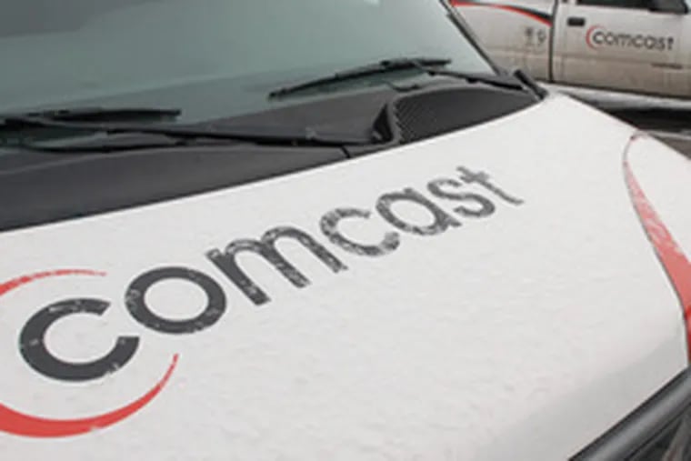 Comcast trucks line up at the cable TV giant&#0039;s center in Englewood, Colo.