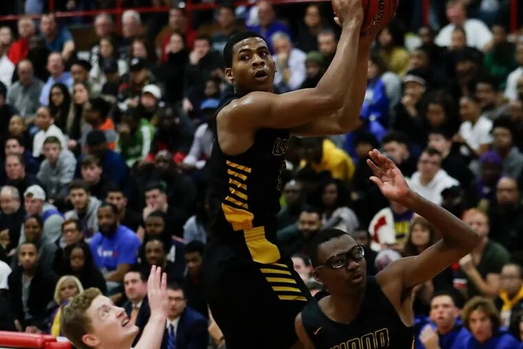 Archbishop Wood High's Muneer Newton (center) grabs the basketball over teammate Brennen Kersey (right) and Wildwood Catholic High's Jacob Hopping in the first-quarter during the Dajuan Wagner Play-By-Play Classic at Cherry Hill East High School on Monday, December 30, 2019.