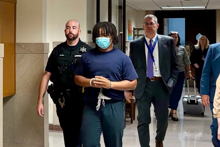 Justin Davis is escorted out of a courtroom Tuesday in the Montgomery County Courthouse. Davis, 17, admitted he participated in the fatal robbery of William Carter in January.