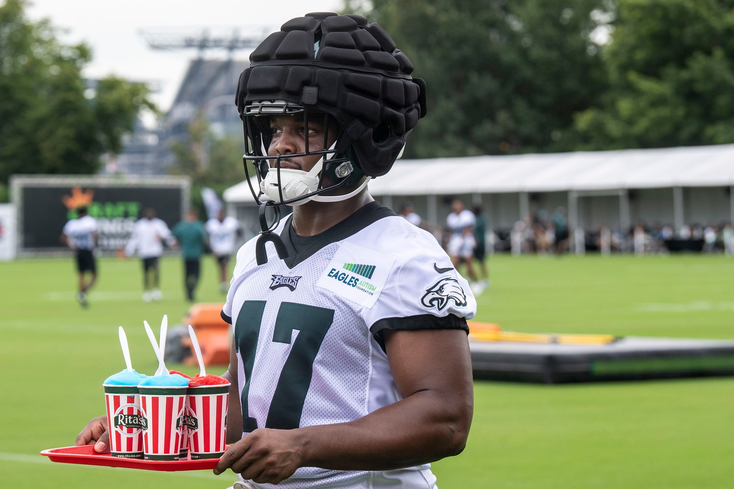 Philadelphia Eagles' Jalen Hurts, left, signs a jersey for a member of the  military's family during practice at NFL football team's training camp,  Saturday, July 30, 2022, in Philadelphia. (AP Photo/Chris Szagola