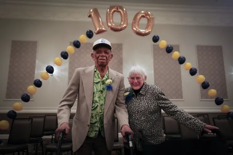 Herman Whilby (left), 106, and Sarah Narvel (right), 103, pose under a balloon arch during the annual Delaware County Centenarian Celebration in Drexel Hill on Thursday, May 16, 2024.