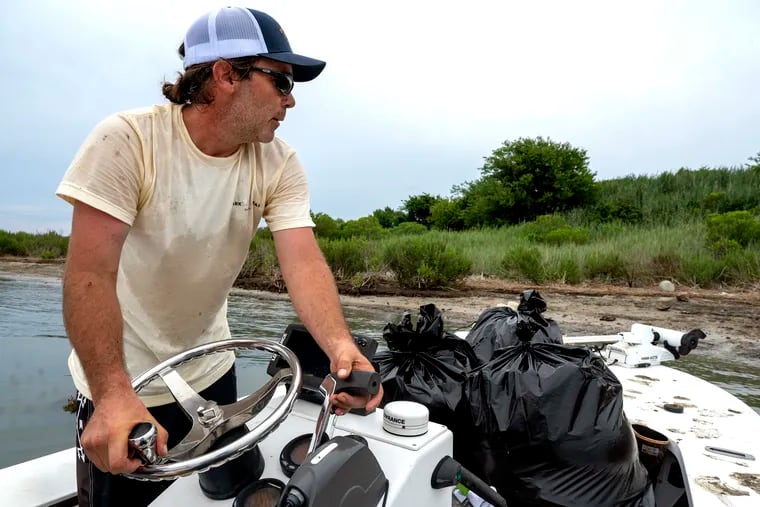 John Kauterman steers his skiff off an island near Wildwood.