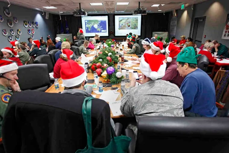 Santa trackers field calls and answer e-mails at NORAD Tracks Santa, Peterson Air Force Base, Colo. Tracking Santa's travels is a celebrated tradition in its 55th year.