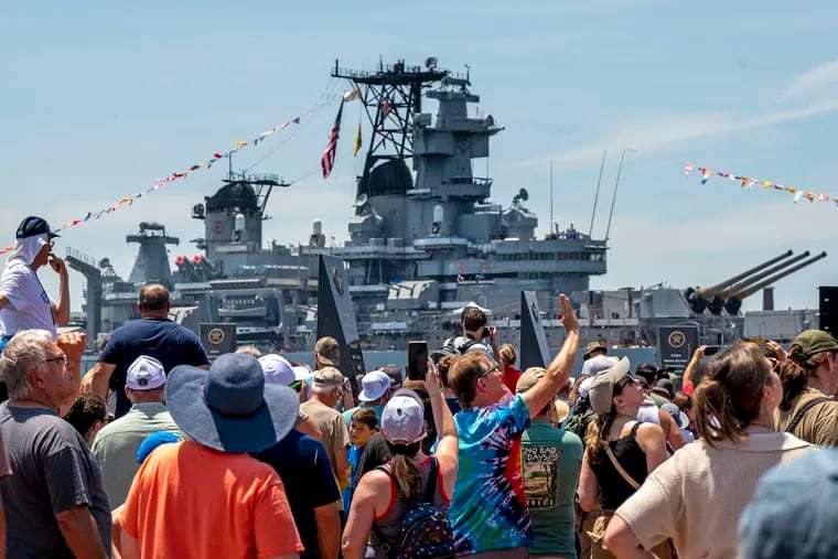 Crowds greet the Battleship New Jersey as it returns home to the Camden Waterfront Thursday, June 20, 2024, after a restorative hull repainting and other maintenance work in Philadelphia.