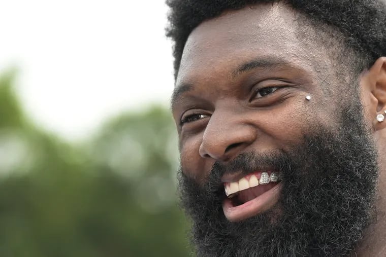 The Eagles’ Josh Sweat shares a laugh with reporters on Monday during training camp at the NovaCare Complex.