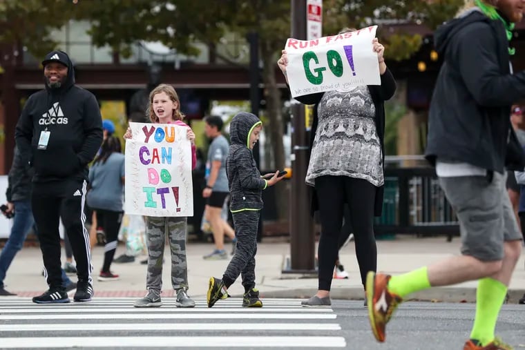 Adalyn Finegan, 9; AJ Finegan, 6; and Shannon Finegan, all of Haddonfield, cheered on the runners at Pattinson and 11th Streets during the Broad Street Run in October 2021.