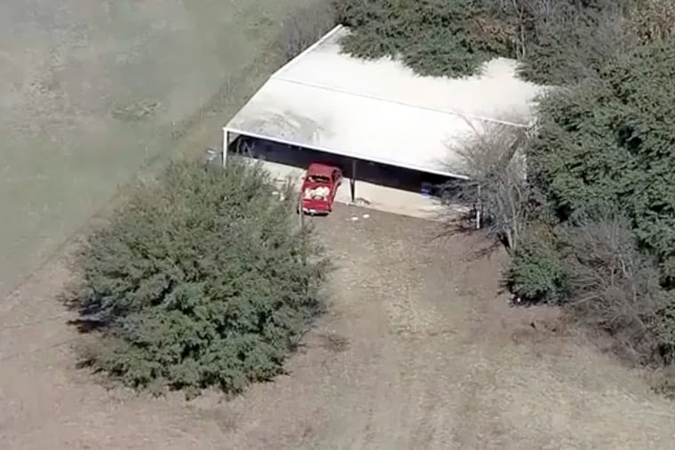 This aerial image provided by KDFW-FOX4 News shows part of the property where deputies found two young, malnourished children locked together in a dog cage near Rhome, Texas, about 20 miles northwest of Fort Worth. (AP Photo/KDFW-FOX4 News)