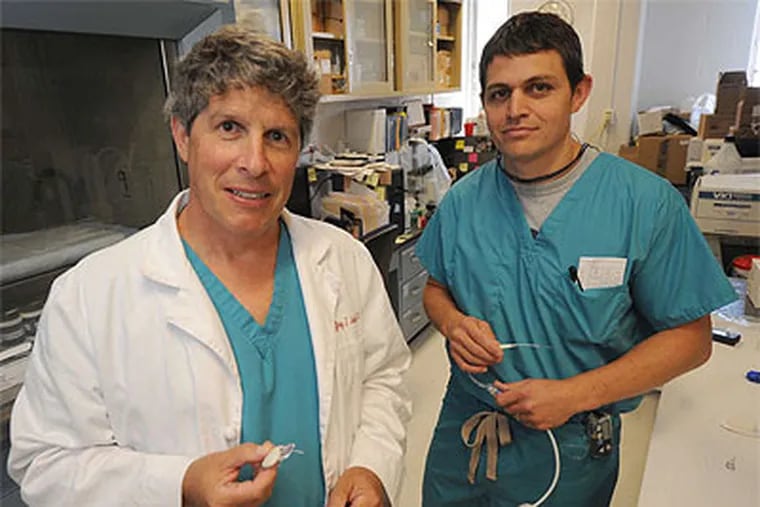 Jefferson Medical College's Jeffrey Joseph (left) and Brian Hipszer with diabetes management devices.  (April Saul / Staff Photographer)