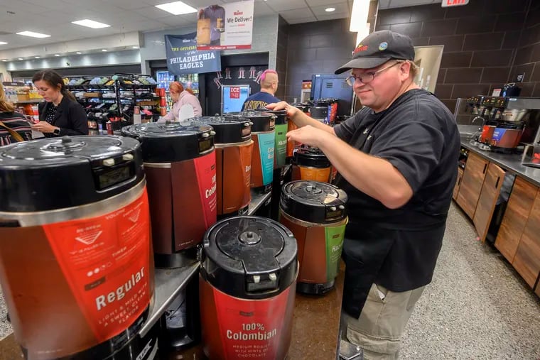 John Mitchell, a long-time Wawa employee with developmental disabilities, tends to the coffee station at the South Philadelphia Columbus Blvd. store, October 21, 2019.