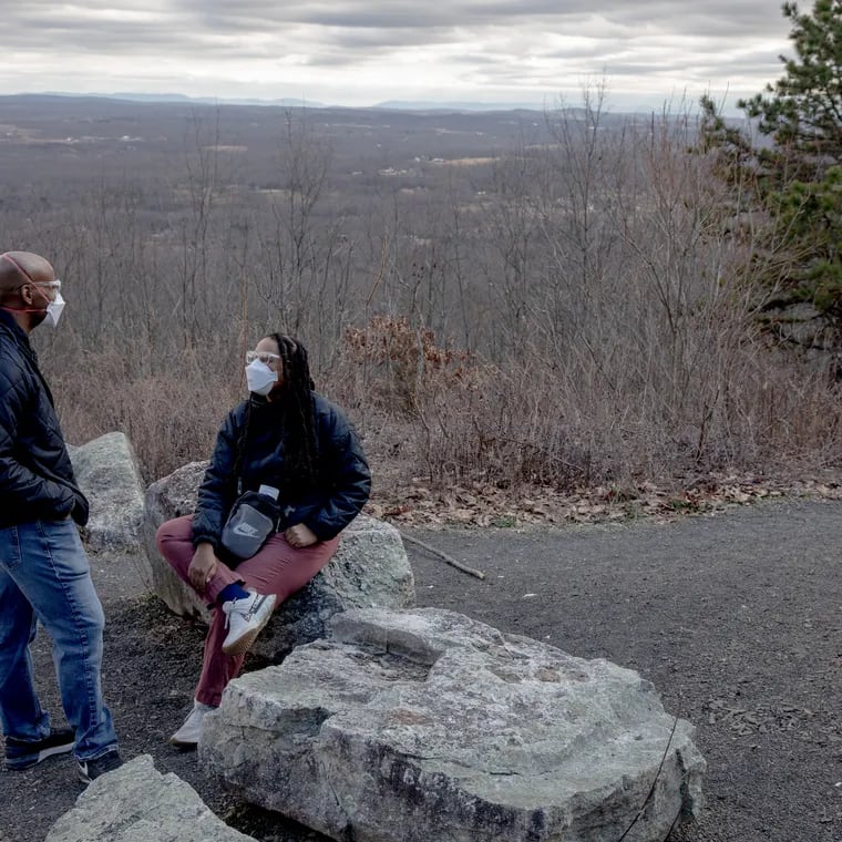 Jeanine Hays and husband Bryan Mason on a hiking trail in Napanoch, N.Y. Because her long covid has many symptoms, they take precautions like wearing N95 masks outside. MUST CREDIT: Yehyun Kim for The Washington Post