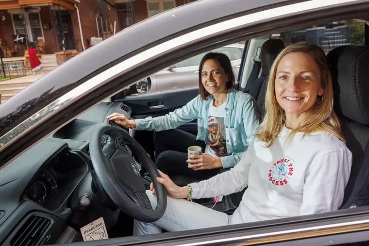 At left is Marilyn Candeloro, with spouse Maura Gallagher, outside their home in Kingsessing section of Philadelphia. They currently drive to Sixers games at the Wells Fargo in South Philadelphia, and hope that can continue if a new arena is built in Center City.