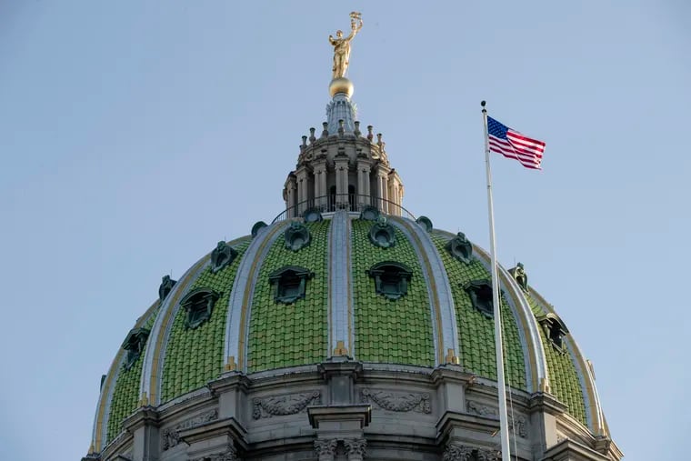 In this Jan. 15, 2019, file photo an America flag flies at the Pennsylvania Capitol building in Harrisburg, Pa.