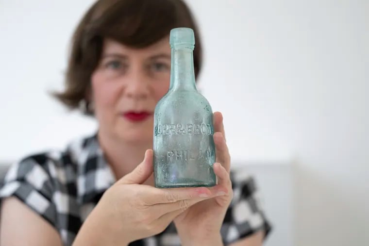 Amy Smyth Murphy holds a message bottle she found in Ocean City, N.J. Murphy, a South Jersey greeting card designer, found the bottle during an early beach walk.