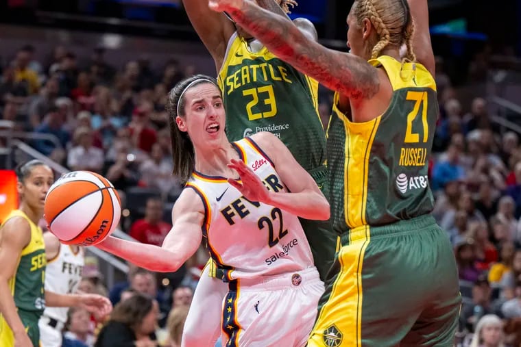 Indiana Fever guard Caitlin Clark passes the ball while being defended by the Seattle Storm's Jordan Horston on May 30.