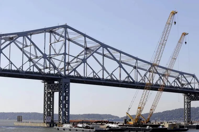 Cranes surround the construction site at the Tappan Zee Bridge that spans the Hudson River near Nyack, N.Y., Monday, Oct. 6, 2014. A large crane called the Left Coast Lifter that arrives Monday will assist in the ongoing construction at the bridge. (AP Photo/Seth Wenig)