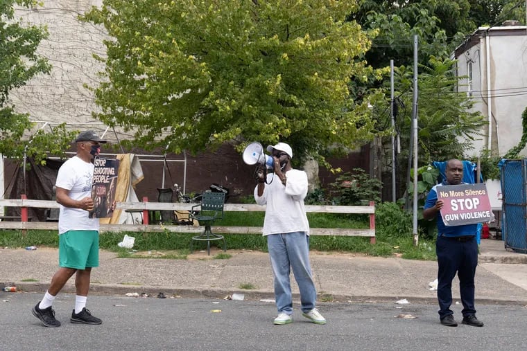 Anti-gun violence activists (left to right) Jamal Johnson, Leroy Muhammad, and Bhoke Lumumba on the 1800 block of West Susquehanna Avenue in Philadelphia on July 16, the day after a triple shooting in which a 14-year-old girl was shot by a stray bullet in front of her home.