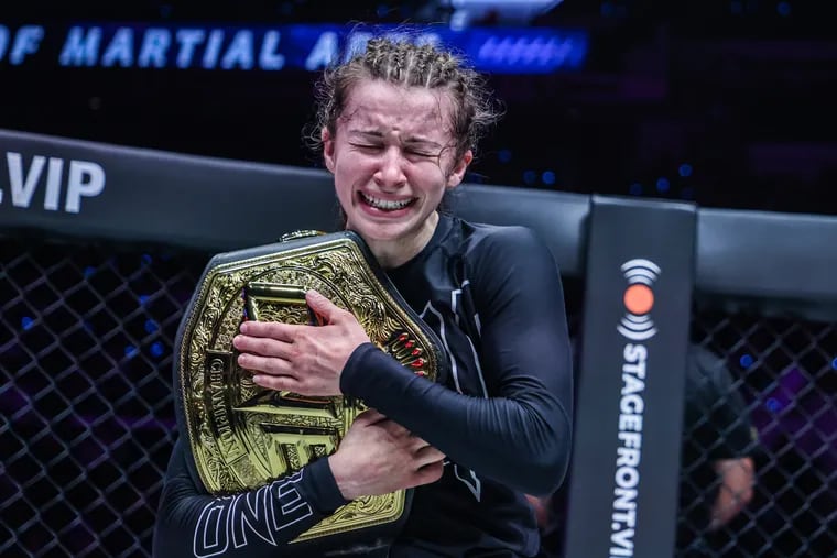 Danielle Kelly reacts with her belt after beating Jessa Khan for the ONE Championship women's atomweight submission grappling world title.