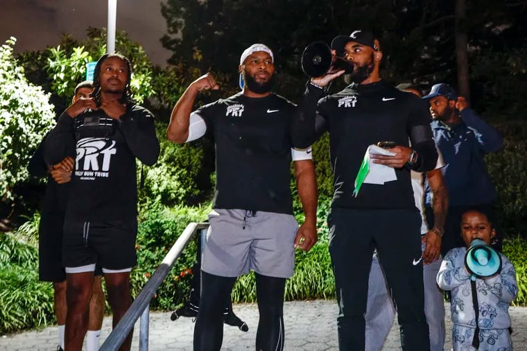 Hamza Muhammad (center) and his brother Abdul address the hundreds who attended the Philly Run Tribe's final run of the season on Oct. 1.