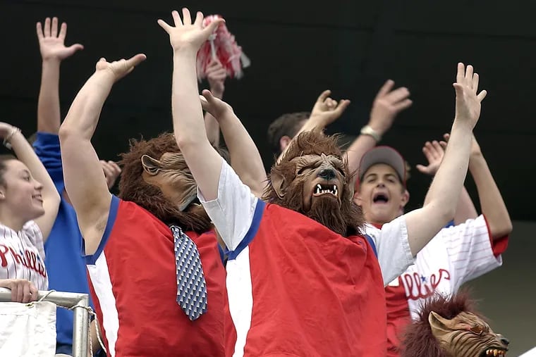 Joe Wood (center)  and the Wolf Pack cheer as Phillies' pitcher Randy Wolf gets an out.