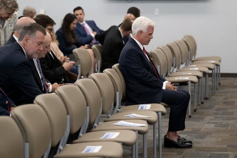 George Norcross III sits in the front row before an announcement by New Jersey Attorney General Matthew J. Platkin charging him on racketeering charges. Norcross was charged Monday with operating a racketeering enterprise, threatening people whose properties he sought to take over, and orchestrating tax incentive legislation to benefit organizations he controlled.