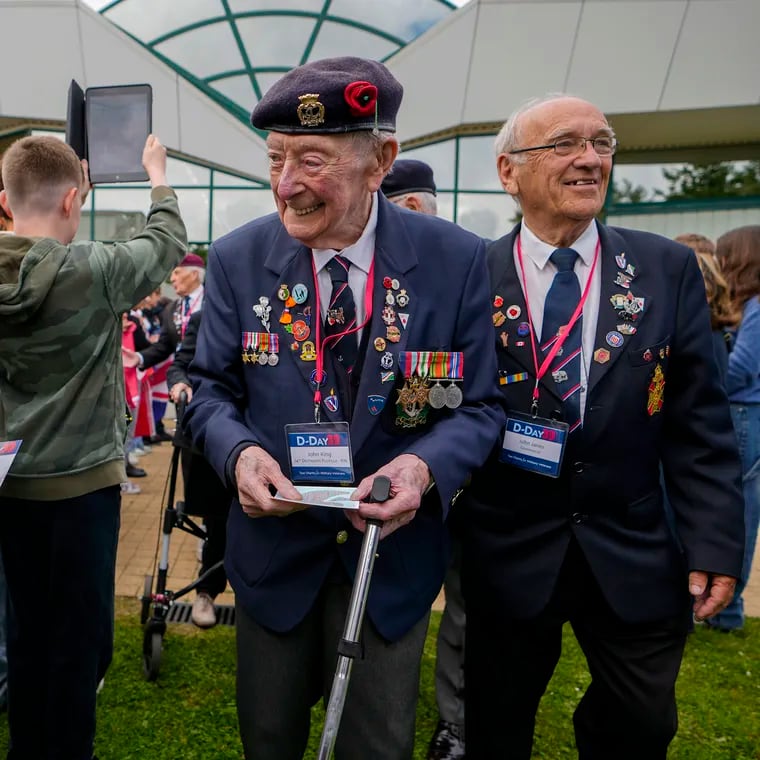 British World War II veteran John King is greeted by a young girl prior to a service at the Pegasus Bridge memorial in Benouville, France, Normandy, on Wednesday.  World War II veterans from across the United States as well as Britain and Canada are in Normandy this week to mark 80 years since the D-Day landings that helped lead to Hitler's defeat.