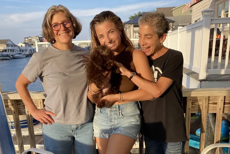 The author (right) with her partner Elissa (left), daughter Sasha, and grand-puppy Cleo Babka. Today is The Inquirer's last Parent Trip column.