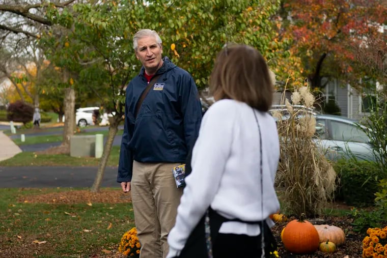 State Rep. Todd Stephens (R., Montgomery), left, campaigns in October in North Wales. Stephens is running in one of two Pennsylvania state House races that remain uncalled and will determine which party controls the chamber.